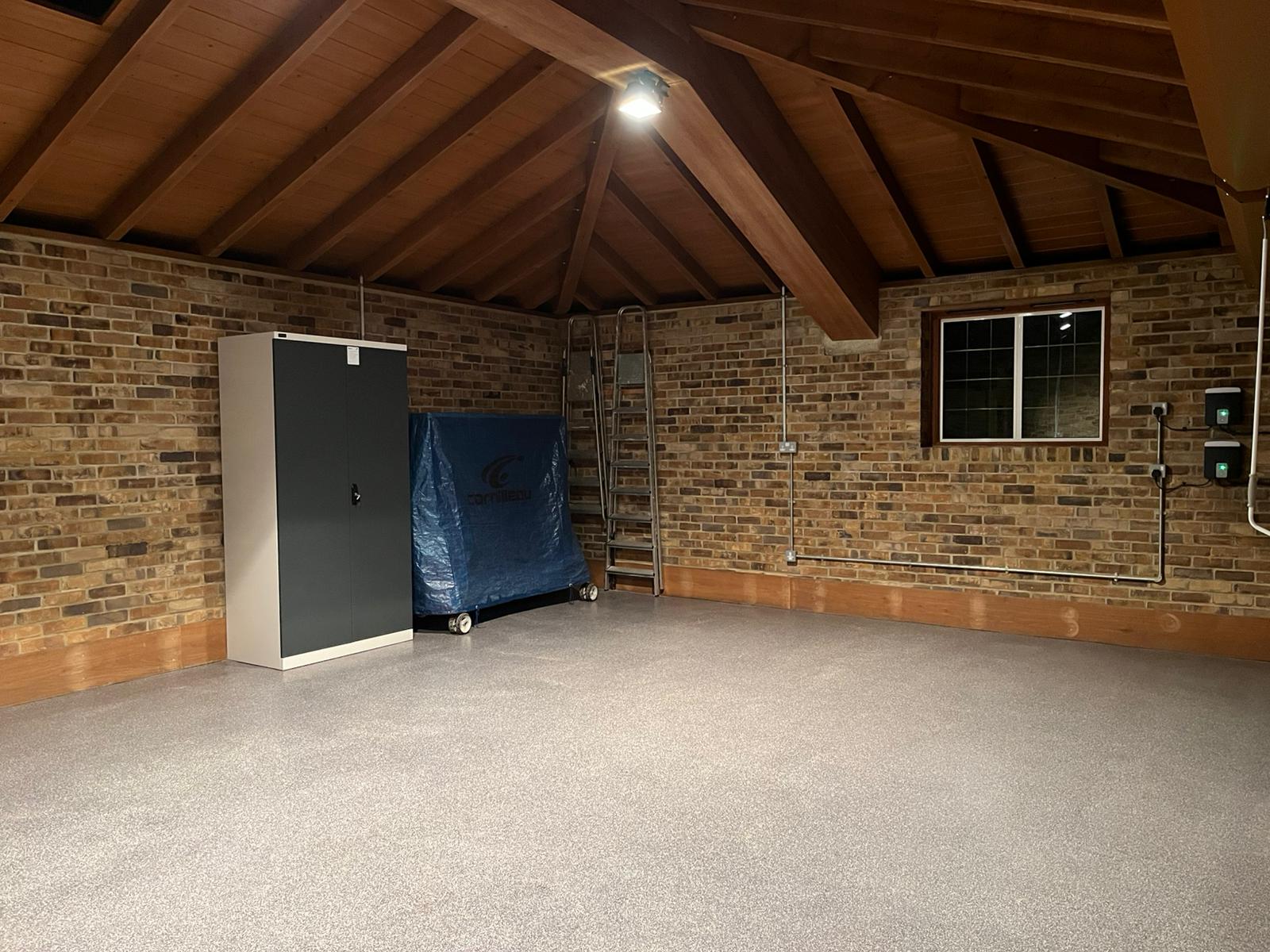 Luxury garage transformation with Hormann Rollmatic doors and resin flooring
